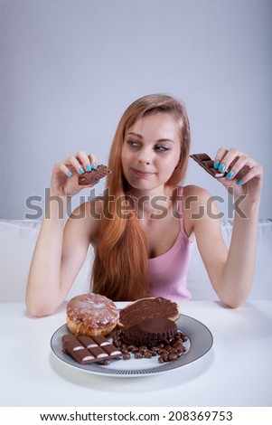 Vertical view of a girl eating sweets