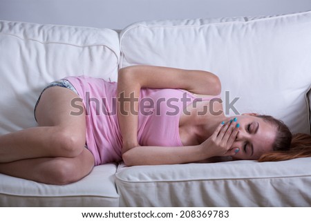 Horizontal view of skinny girl feeling sick