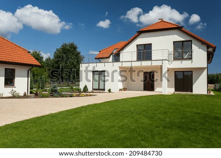 View of beautiful modern house with outbuilding