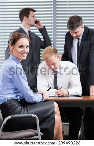 Young employees during teamwork in office, vertical
