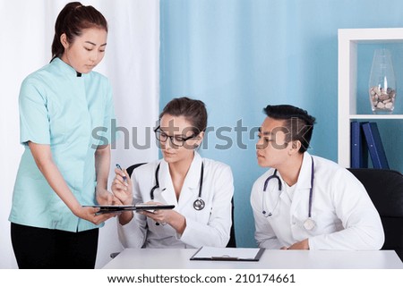 Diverse doctors doing their job in the office