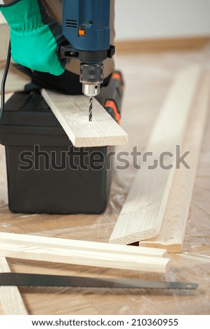 Man with a drill during renovation, vertical