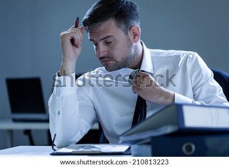 Businessman working overtime in the office, horizontal