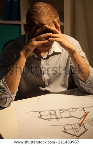 Architect making a project at night, vertical