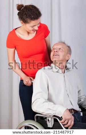 Vertical view of grandfather looking on granddaughter