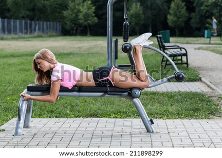 Woman during training on the outdoor gym