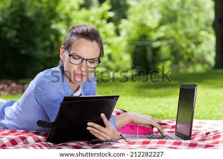 Businesswoman working on computer in a garden