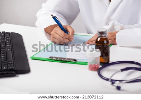 Horizontal view of doctor\'s hands delivering prescription
