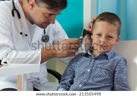 Horizontal view of boy during ear examination