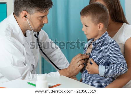 Boy with mother during medical appointment, horizontal
