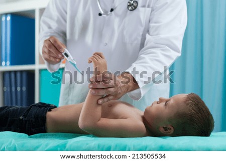 Boy during temperature measurement at pediatrician\'s office