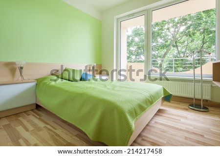 Horizontal interior of bedroom with green elements