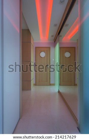 Modern corridor with red neon lighting, vertical