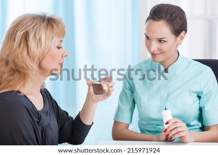 Doctor giving appropriate medicines her middle aged patient