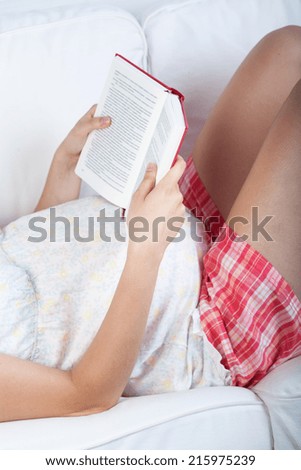 Reading a book on a couch during pregnancy