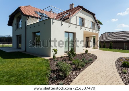Modern suburban house with green minimalist garden