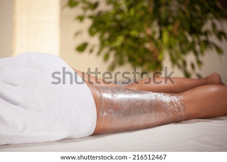 Body wrapping in a spa room, horizontal