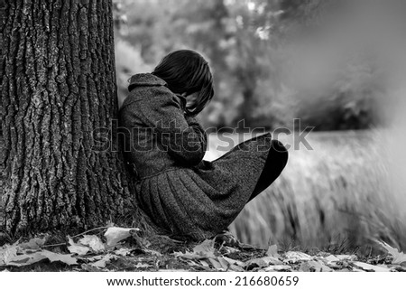 Sad woman crying after break up in the park