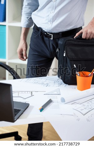 Worker leaving his office after long day at work