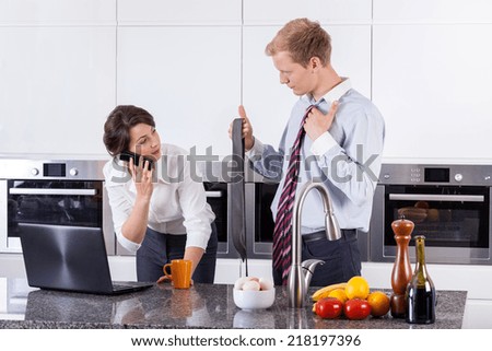 Multitasking woman choosing tie for her partner, horizontal