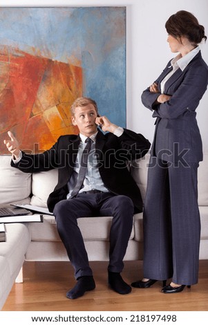 Vertical view of a wife being angry at her busy husband
