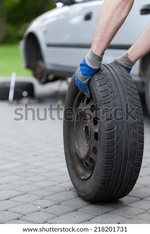 Vertical view of rolling a spare of wheel