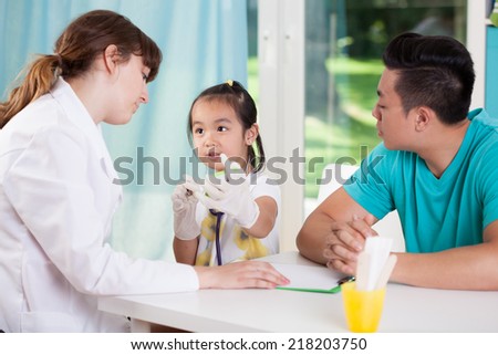 View of asian family at pediatrician\'s office