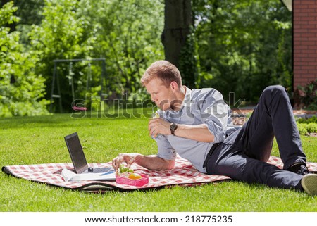 View of businessman relaxing in a garden