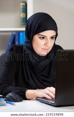 Muslim woman looking at the computer screen