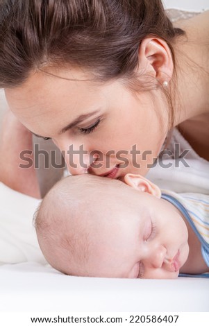 Close-up of mum kissing her newborn baby