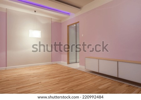 Large purple room with neon lights and white chest