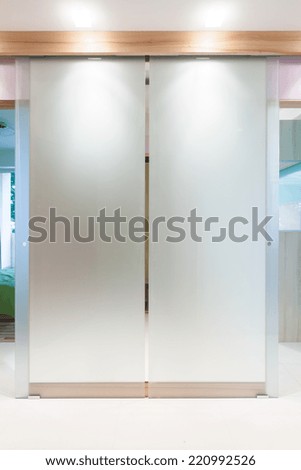 Glass double door in modern apartment\'s hall