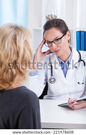 Doctor talking with her female patient, vertical
