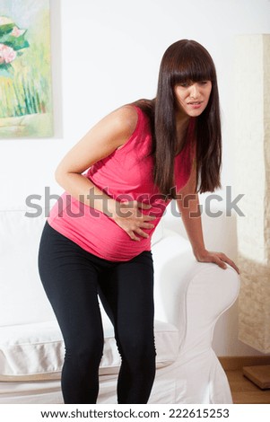 Vertical view of pregnant woman feeling pain