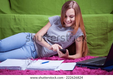 Teenager chatting with friend during studying