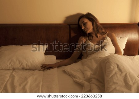 Young woman in bed suffering with longing