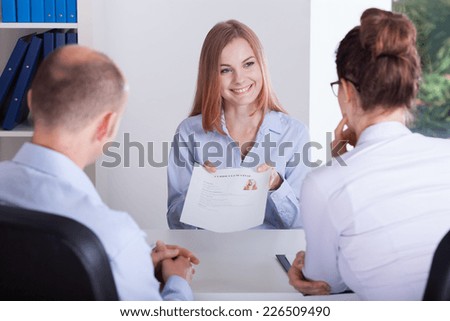 Young female candidate presenting her application on job interview