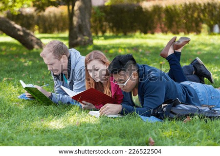 Young multi-ethnic people studying in the park