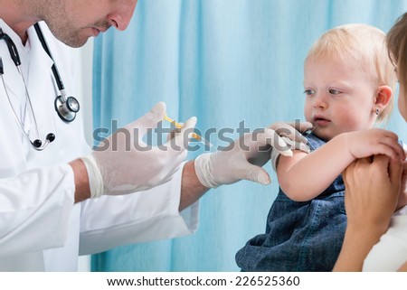Little girl with her mum at doctor\'s office