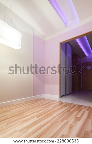 Pastel pink room with door to the hall