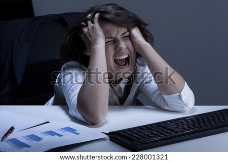 Businesswoman with terrible problem tearing her hair out