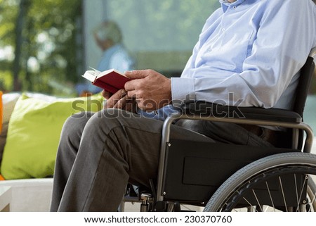 Close-up of older man sitting on wheelchair