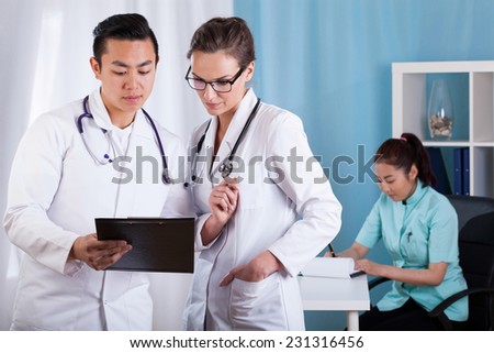 View of diverse doctors talking at work