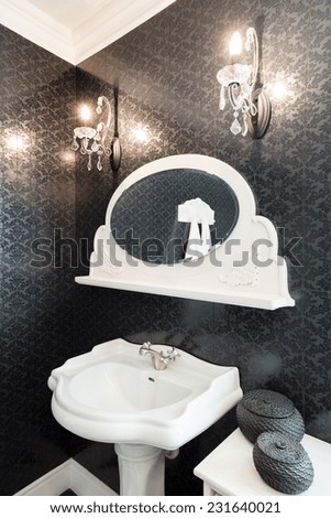 Picture of white porcelain basin with small mirror above