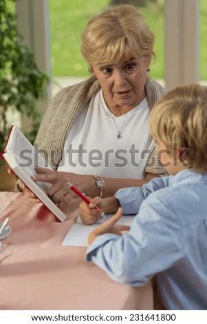 Vertical view of grandma teaching his grandson