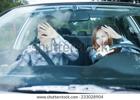 Young couple in car blinded by high beam lights