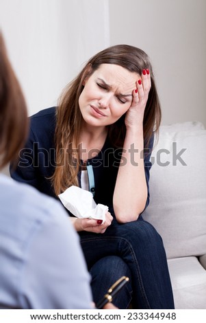 View of crying woman at psychotherapist office