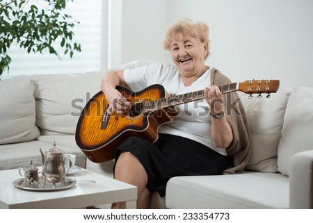 Elderly cheerful woman singing the song