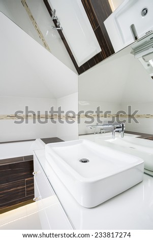 White clean basin with big mirror above