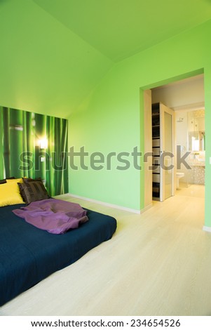 Cozy bedroom interior with green painted walls